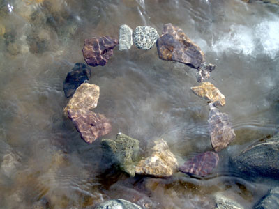 shimmering circle of stones under water