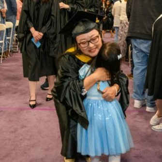 Student embracing daughter at graduation placeholder image
