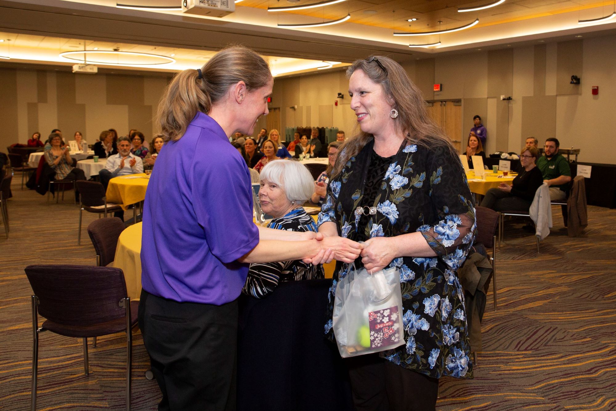 Dr. Martin shaking hands with staff member