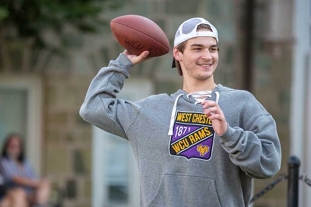 Student throwing football