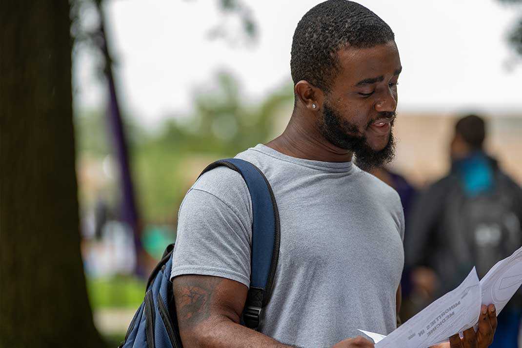 Graduate student looking at documents