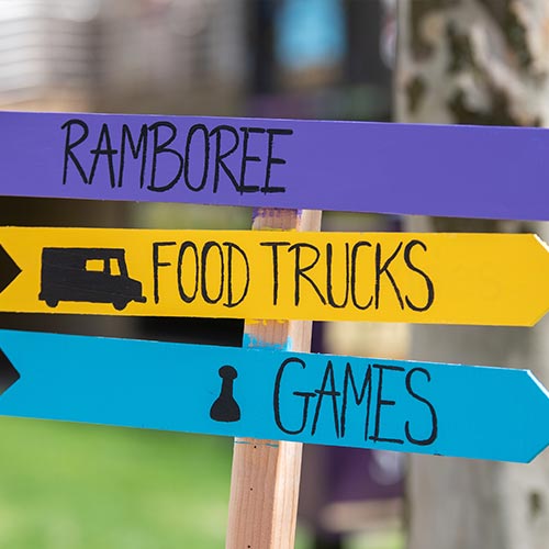 Sign saying ramboree, food trucks, games