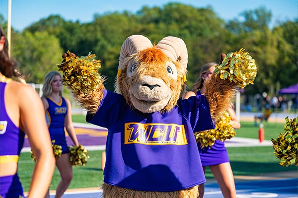 Rammy waving pompoms at the homecoming game