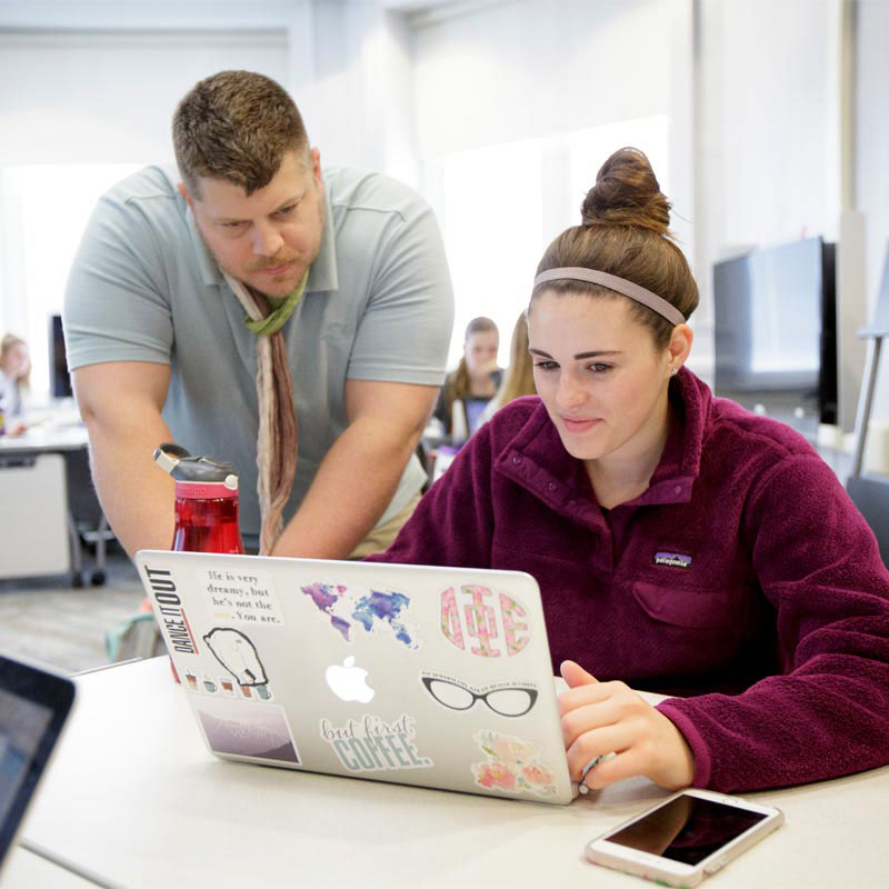 Student and Faculty on computer