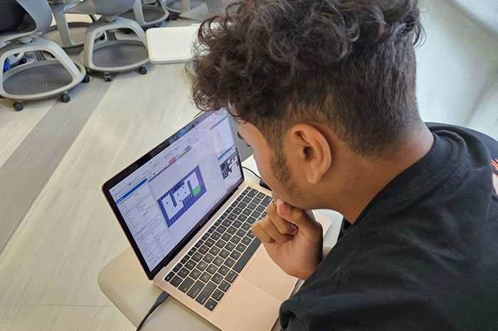 ICamp student working on laptop
