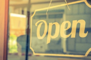 Image of "Open" sign in business storefront window