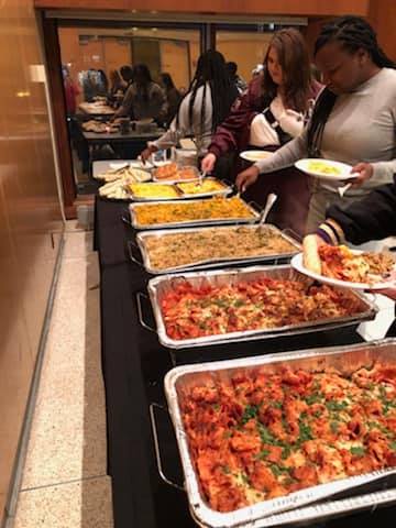 Foil trays with food; students serving themselves