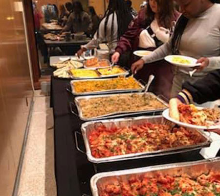 Foil trays with food; students serving themselves thumbnail