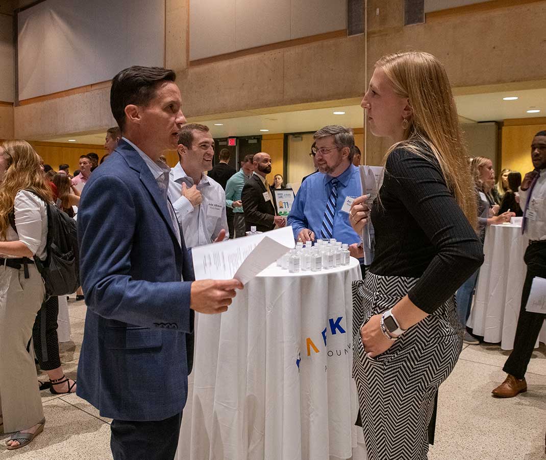 Female student meeting with employer at Business event