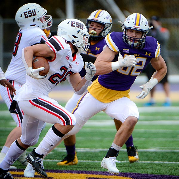 WCU football Player running with the football