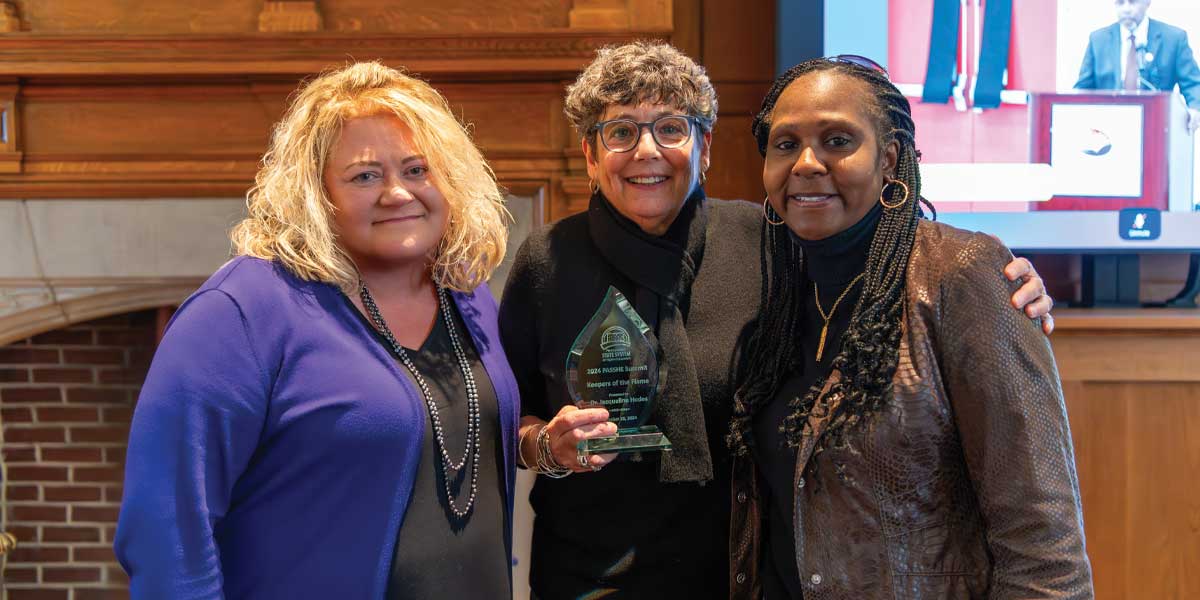 Pictured at the Keeper of the Flame Award ceremony on campus are (L-R) Dr. Laurie Bernotsky, president; Dr. Jackie Hodes, honoree and HEPSA department chair; and Dr. Tracey Robinson, vice president for the Division for Access, Compliance, and Engagement.
