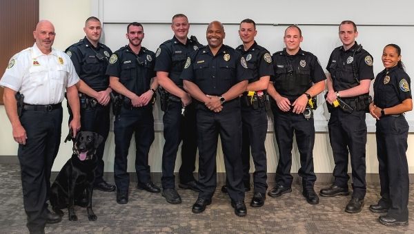 Pictured (L to R) immediately following the introduction and welcoming of six new West Chester University Police Officers: Captain Robert Herzog & Remi, safety dog; Ofc. Kevin Skymba; Ofc. Lorenzo Giannandrea; Ofc. Jeffrey Shumate; Director and Chief of Police Ray Stevenson (center); Ofc. Peter Gardner; Ofc. Christopher Traini; Ofc. Matthew Lanshe; and Lieutenant Laura McGill. 
