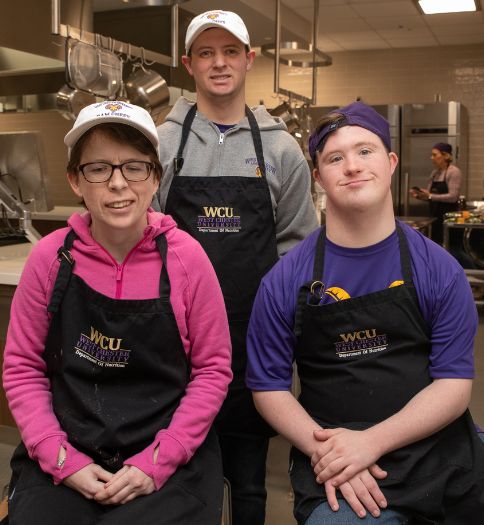 Ram Chefs are pictured following snack-prep. Pictured (sitting l to r) are Amy Vermeil, Patrick Ray, and (standing) TJ Fulginiti.