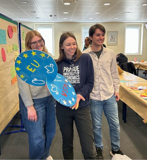 Gwyn Bartholomew, a WCU junior political science-international relations major from Doylestown, a student from Czechia, and WCU student Jacob Moser posing with their art project during the final day of the European Academy Otzenhausen workshop.