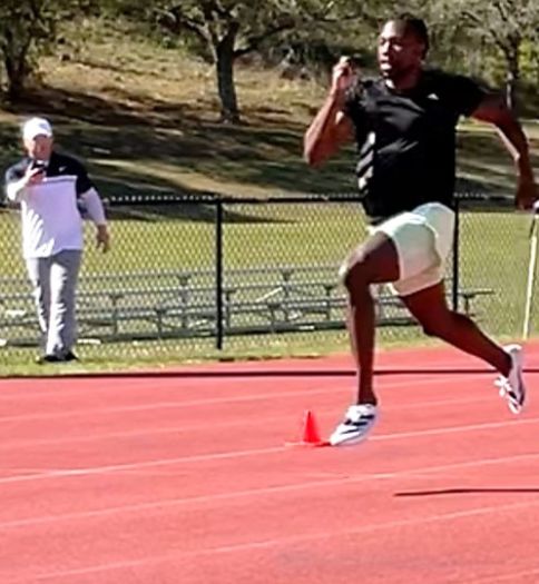 Dr. Ken Clark ’09, assistant professor of kinesiology, consults with Paris Olympics 100 meters gold medalist Noah Lyles 