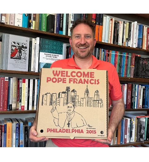 Dr. Michael A. Di Giovine, professor of anthropology at West Chester University, with a pizza box from 2015 that was created to welcome Pope Francis to Philadelphia. 