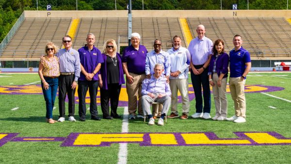 (L to R) Pictured on Tomlinson-Fillippo Field are Agnes Ware, Roger Ware ’82, Head Football Coach Duke Greco, West Chester University President Dr. Laurie Bernotsky, Robert “Tommy” Tomlinson ’70, Tom Fillippo ’69 (sitting), Vice President for University Advancement and External Affairs Dr. Zebulun Davenport, Vice President of University Affairs and Chief of Staff Andrew Lehman, Director of Athletics Terry Beattie, Executive Director of the West Chester University Foundation Deb Cornelius, and Interim President of Commonwealth University Dr. Jeffery Osgood, Jr. 