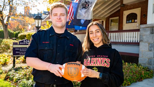 West Chester University students Sophia Feliciano and Dylan Logue hold the game ball outside WCU’s Veterans Center ahead of the University’s Military and First Responder Appreciation Game. Feliciano, a Marine Corps veteran and junior criminal justice major from Coatesville, Pa., and Logue, a senior criminal justice major and firefighter with Fame Fire Company from Montgomery County, Pa., will serve as honorary captains during the November 1 game at Farrell Stadium.