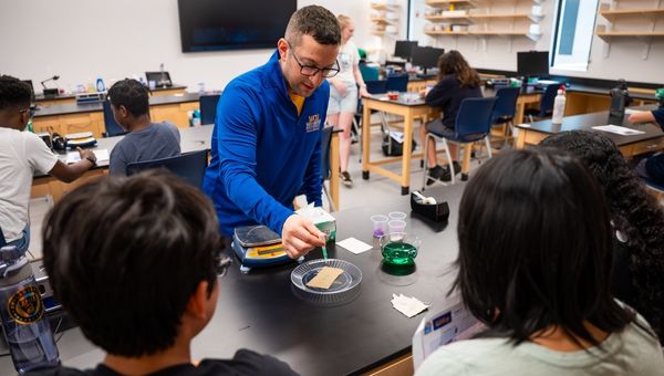 Dr. Brandon Mitchell, professor of physics and engineering who helped establish and currently leads West Chester University’s Center for STEM Inclusion, is pictured working with high school students in a recent workshop held on campus to introduce the youth to career fields in science, technology, engineering, and mathematics.