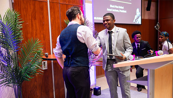 Black Men United President Amari Jackson accepting the Student Organization Leadership and Community Service Award for BMU