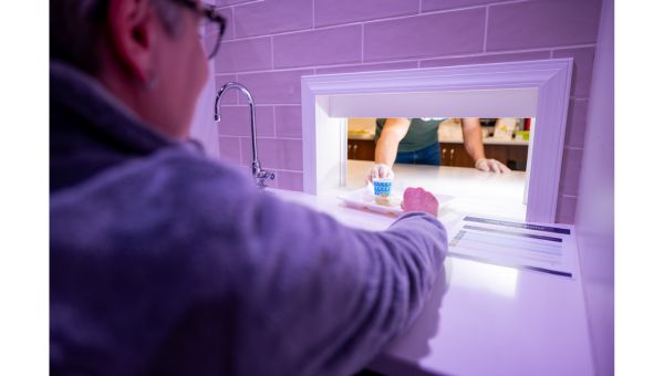 A judge recieving pistachio quick bread inside the Food and Sensory Lab