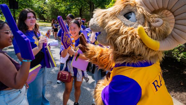 Rammy high fiving students
