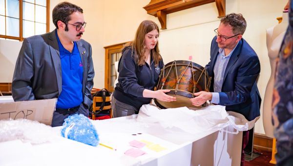 (L to R) Pictured are Roman Straub, Violet Curran, and Dr. Michael A. Di Giovine as they examine the Civil War Infantry Regulation Field Drum from the Hartenberger World Music Collection in St. Louis, Missouri.