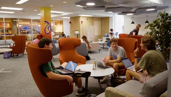 Students enjoying the space at One Stop, located in FHG Library