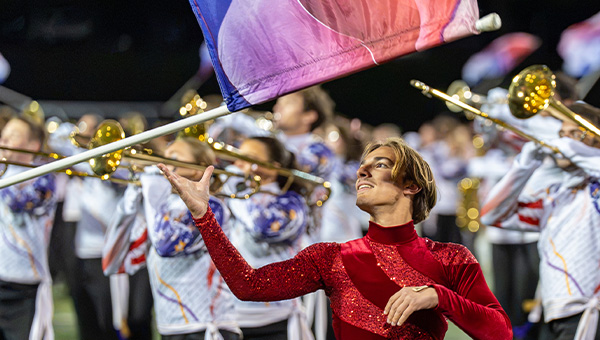 WCU's Marching Band on the Field. Red Flag Holder in the front. 
