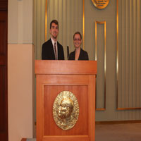 Thumbnail: Two people at a podium 2
