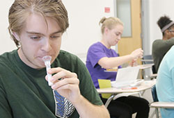 Student examining test tube