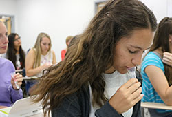 Student spitting saliva into test tube