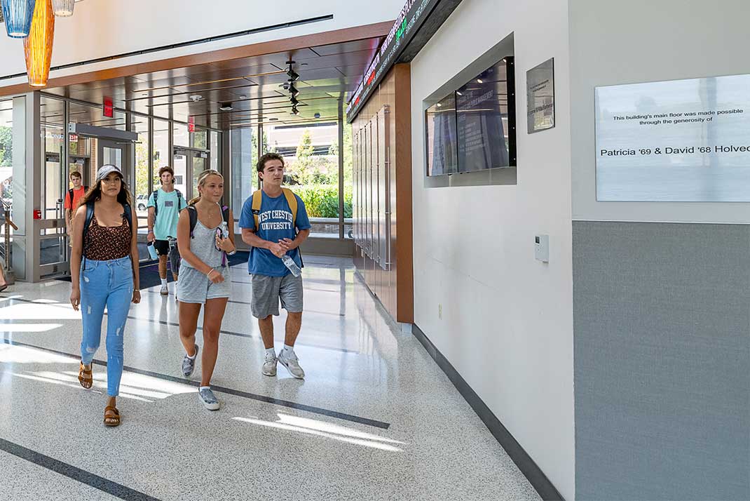 
						 Students walking through building 
					