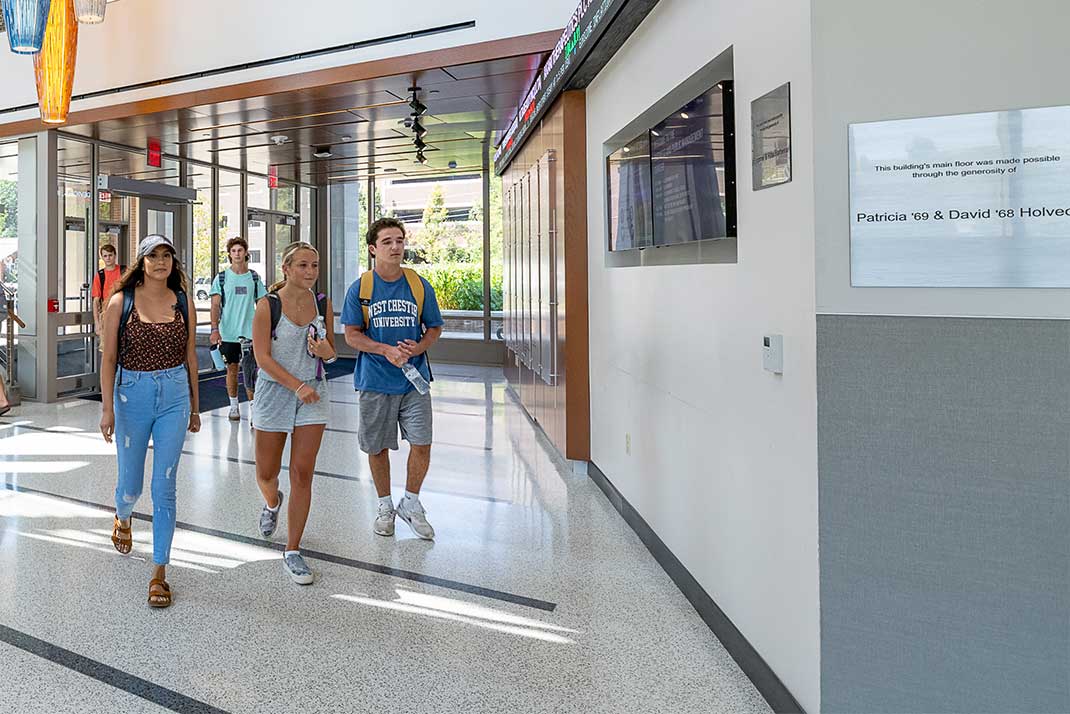 
 Students walking through building 
