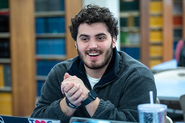 Male student posing in library