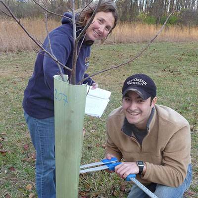 Students Kendra McMillin and Tim Ponticello  monitoring the survival and growth of trees planted at the GNA