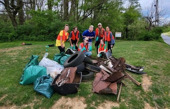 A group of the volunteers with just a portion of the trash they removed from the stream
