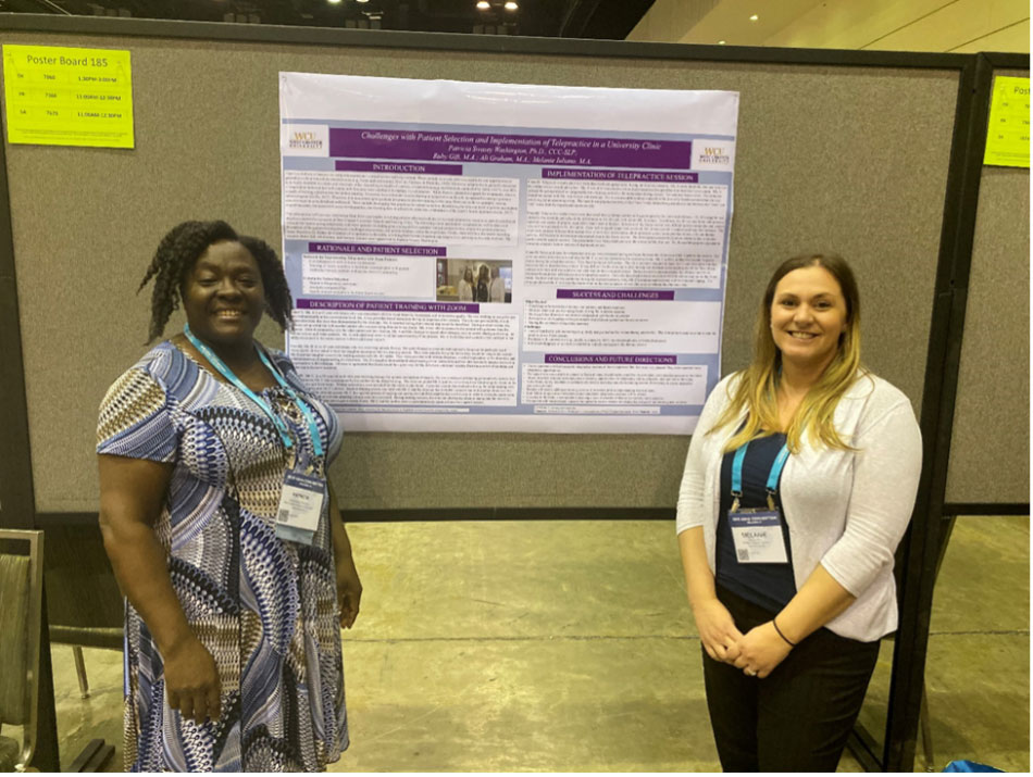 2 women standing in front of a presentation poster.
