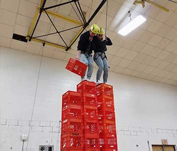 Students climbing crates
