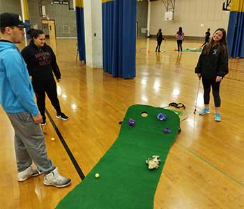 students playing golf