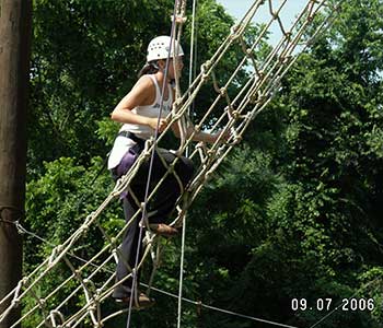 Student climbing rope