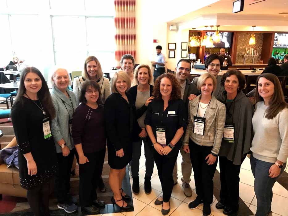 Large group of alumni and faculty at FNCE