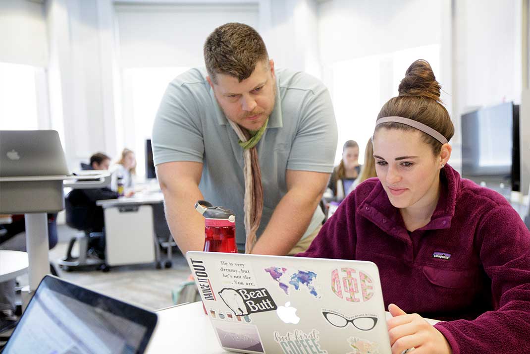 Faculty member working with student