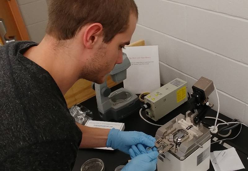 A student prepares a sample for the AFM