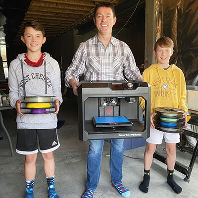 3 boys holding 3D Printer materials