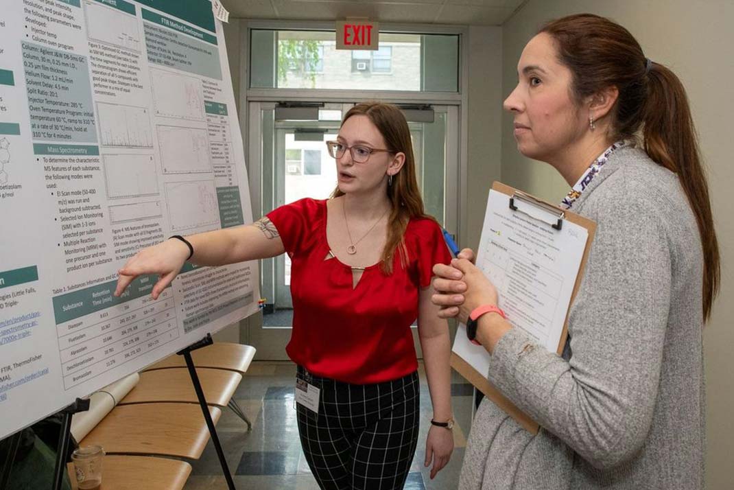 Woman pointing at poster session