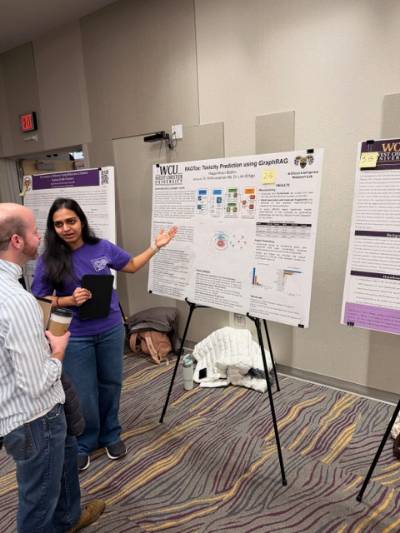 Raga Moni Batchu explains her poster at the CSM Fall Poster Presentation Event