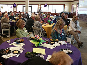Senior citizens with WCU stundents sitting at tables