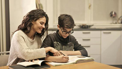Mother helping child with homework.