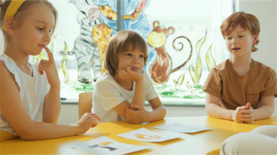 A group of children sitting at a table.